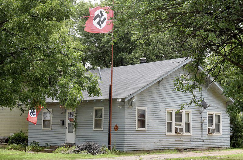 Man displaying swastikas arrested for shooting woman taking flag